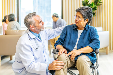 Professional doctor talk and encourage to elderly woman hand who sitting on the wheelchair at hospital, Caregiver provide care medical service help support smiling old grandma at home care medicalの写真素材