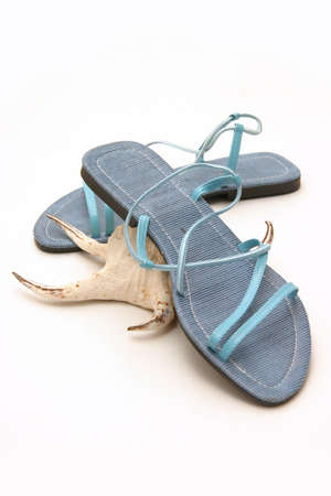 A pair of size eight blue ladies sandals on white backgroundの写真素材