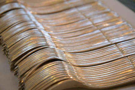 Rows of silverware spoons and forks