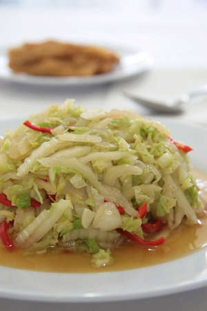 Chinese style fried thinly sliced cabbage strips with chili and onionsの写真素材