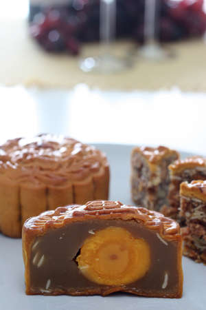 Halved Chinese mooncake showing its core of duck egg yolk and lotus seed pasteの写真素材