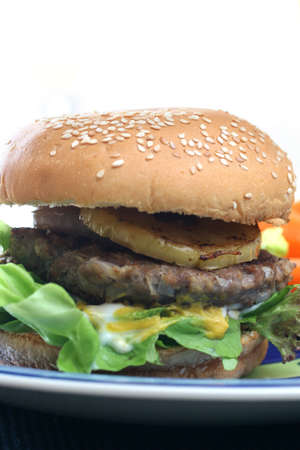 Healthier homemade grilled burger with carrots and plenty vegetablesの写真素材