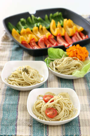 Assorted dishes of Pasta olio with multi colored rows of capsicumsの写真素材