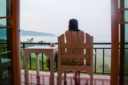 Woman on the porch for view fogのeditorial素材