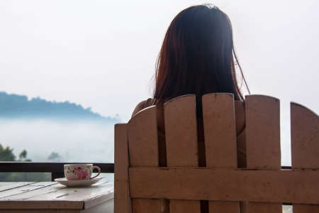 Woman on the porch for view fogの写真素材