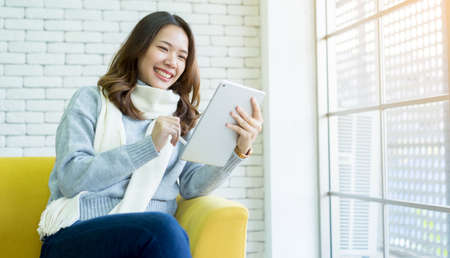 close up international student woman using tablet with pen for checking homework or research project...