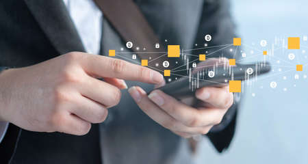 close up businessman hand hold smartphone to use blockchain to transfer or trading on cryptocurrency...