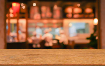 old vintage brown wood tabletop with blurred restaurant bar cafe light color background: for show or...