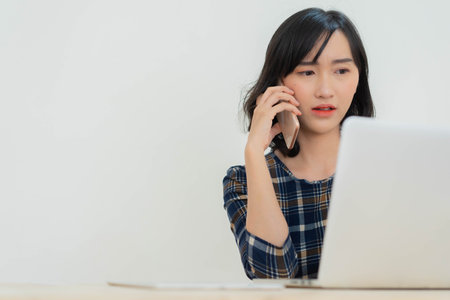 close up Japanese asian businesswoman calling to conference with partner and employee to consult about working in quarantine time for work from home conceptの写真素材