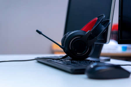 close up gamer's headset on keyboard desktop computer PC for Esport championship tournament concept