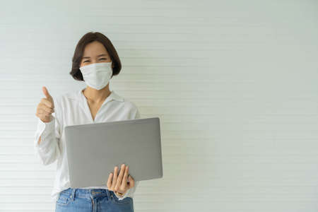 close up young beautiful employee woman using laptop and stand alone over white office background...