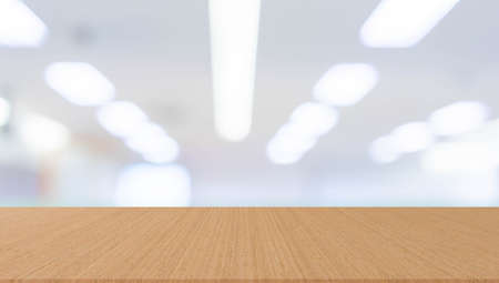 abstract blur inside office with modern wood table perspective for show ads or promote product and...