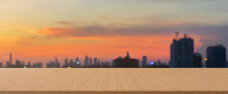 Blurred dark night city background with wood panels perspective for show promote product concept.の写真素材