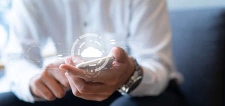 close up businessman hand touchscreen on digital smartphone to transfer or synch data upload and download from cloud computing service with virtual interface for technology business conceptの写真素材