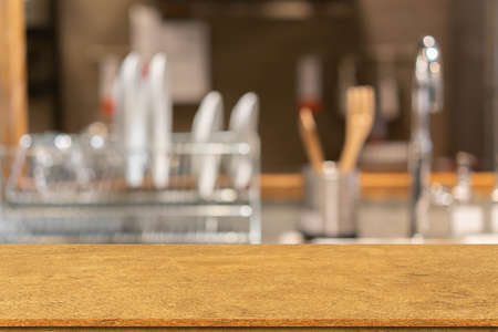 abstract blur inside modern kitchen with cooking equipment and table for show,promote product and...