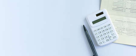 close up top view of calculator,book bank and pencil for counting and planning about monthly...