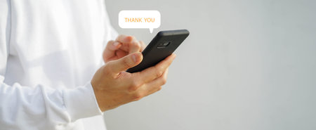 Person using mobile phone with speech bubble message on white background, communication technology conceptの写真素材