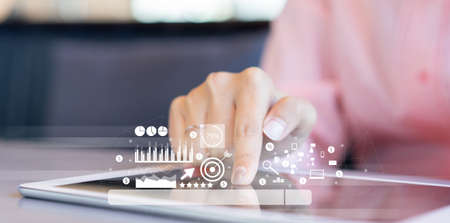 close up businesswoman hand touch screen on digital tablet to use marketing tool and check traffic...