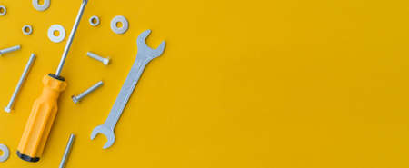 close up top view on group of technical work tool on yellow background for design conceptの写真素材