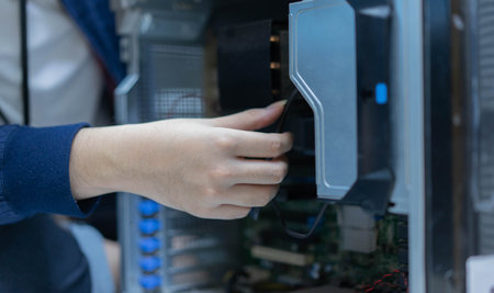 close up it-support technician man hand check mainframe electronic inside computer pc to repair or upgrade performance at server room in. datacenter for technology maintenance conceptの写真素材