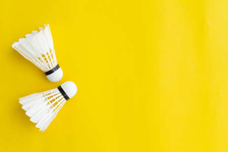 close up top view of white shuttlecocks on yellow color background with copy space for design,show content and promote banner for sport conceptの写真素材
