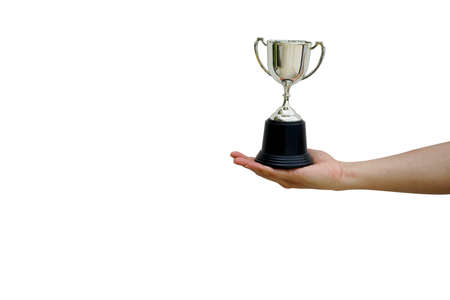 close up man hand hold trophy championship cup isolated on white background for award winner of sport conceptの写真素材