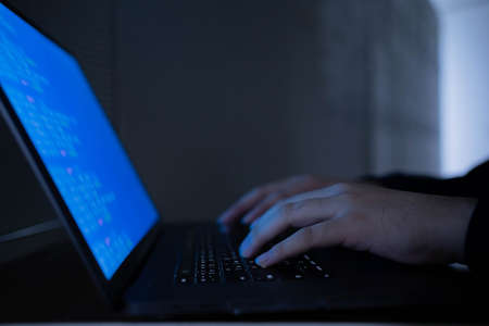 close up specialist programmer hand typing on keyboard on laptop check or command on software for run system at operation data center office for network engineering technology conceptの写真素材