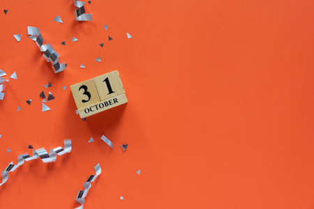 Wooden cube calendar with date of October 31 on orange background.の写真素材