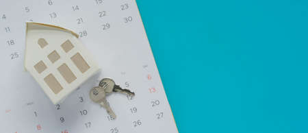 House key on calendar page with copy space. Real estate concept.の写真素材