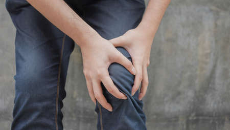 close up man hand massage on knee to relief pain symptom for health concept