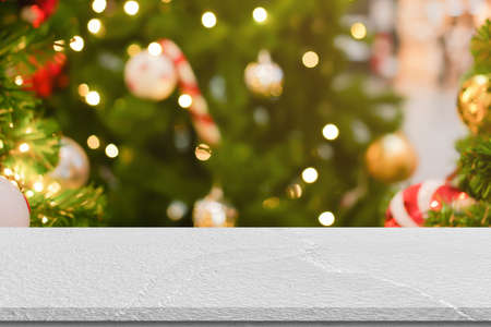Empty white marble table top on blur christmas tree background. For product displayの写真素材