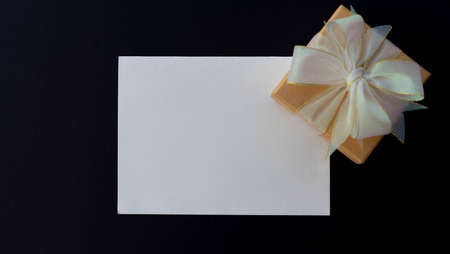 Gift box with blank card on black background. Top view.の写真素材