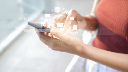 close up young woman using smartphone for choosing item on marketplace website with virtual...