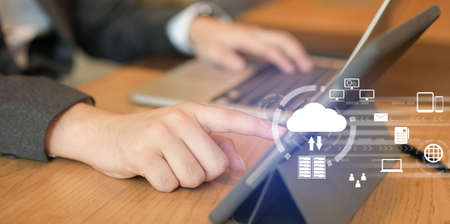 Cloud computing technology concept. Businessman working with modern laptop computer and digital...