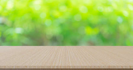 Empty wood table top on blur green bokeh background, for product display montage