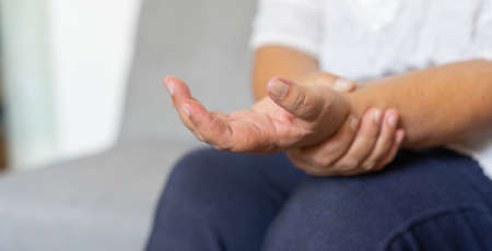 Close-up of senior woman suffering from pain in the elbow.