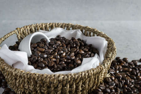 Coffee bean in basket on the stone table.の写真素材