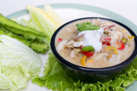 Crab dip with coconut milk and vegetables in bowl.の写真素材