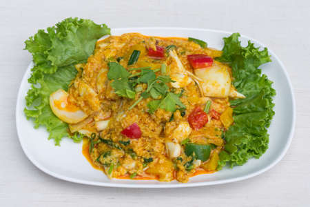 Fried crab with curry powder in white dish on the table.の写真素材