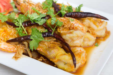 Fried shrimp with tamarind sauce in white dish on table.の写真素材
