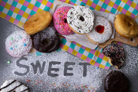 Donut with chocolate glazed and strawberry glazed in wooden tray on concrete table.の写真素材