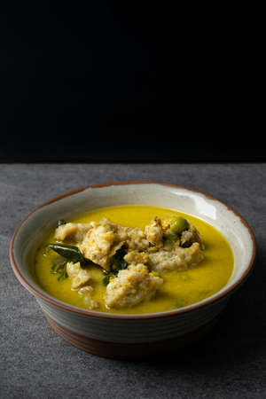 Fish ball green curry in gray bowl on concrete table.の写真素材