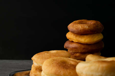 Donuts on stainless tray on the black background.の写真素材