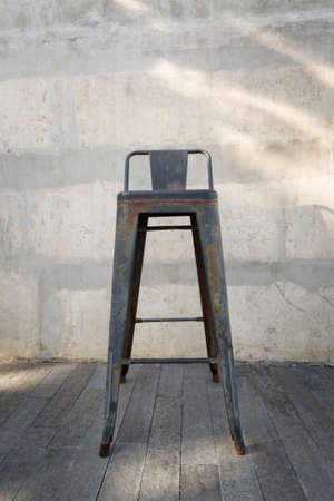 Steel bench in the park on wooden floor with concrete background.の写真素材