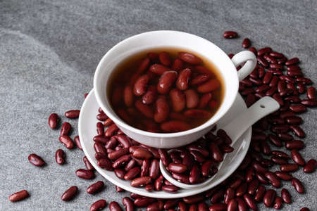 Sweet boiled red beans in white cup on concrete table.の写真素材