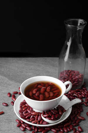 Sweet boiled red beans in white cup on concrete table.の写真素材