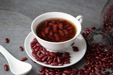 Sweet boiled red beans in white cup on concrete table.の写真素材