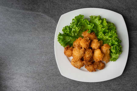 Fried chicken and lettuce in white dish on table.の写真素材