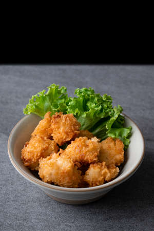 Fried chicken and lettuce in gray bowl on table.の写真素材