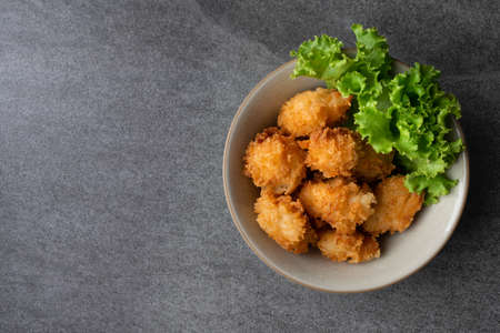 Fried chicken and lettuce in gray bowl on table.の写真素材